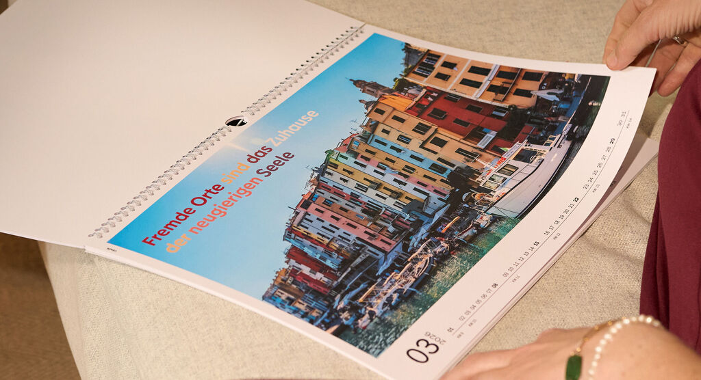 CEWE Fotokalender mit buntem Hafenmotiv und inspirierendem Spruch.